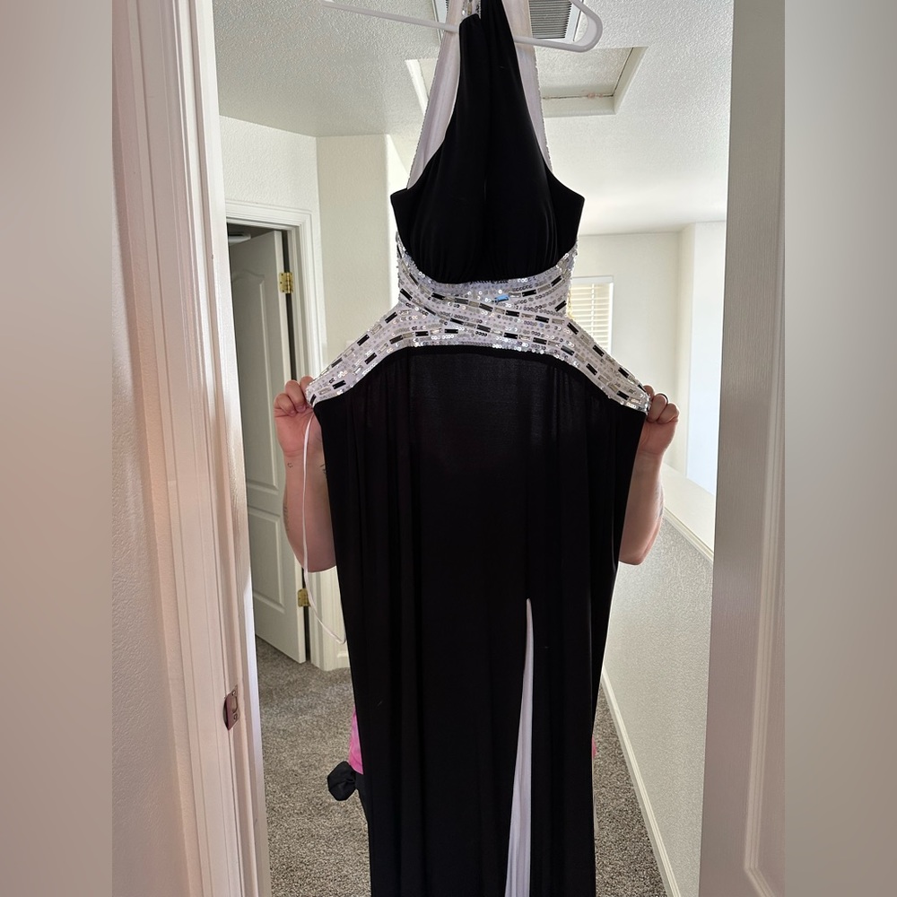 Black and white floor length, high slit prom dress with silver detailing.